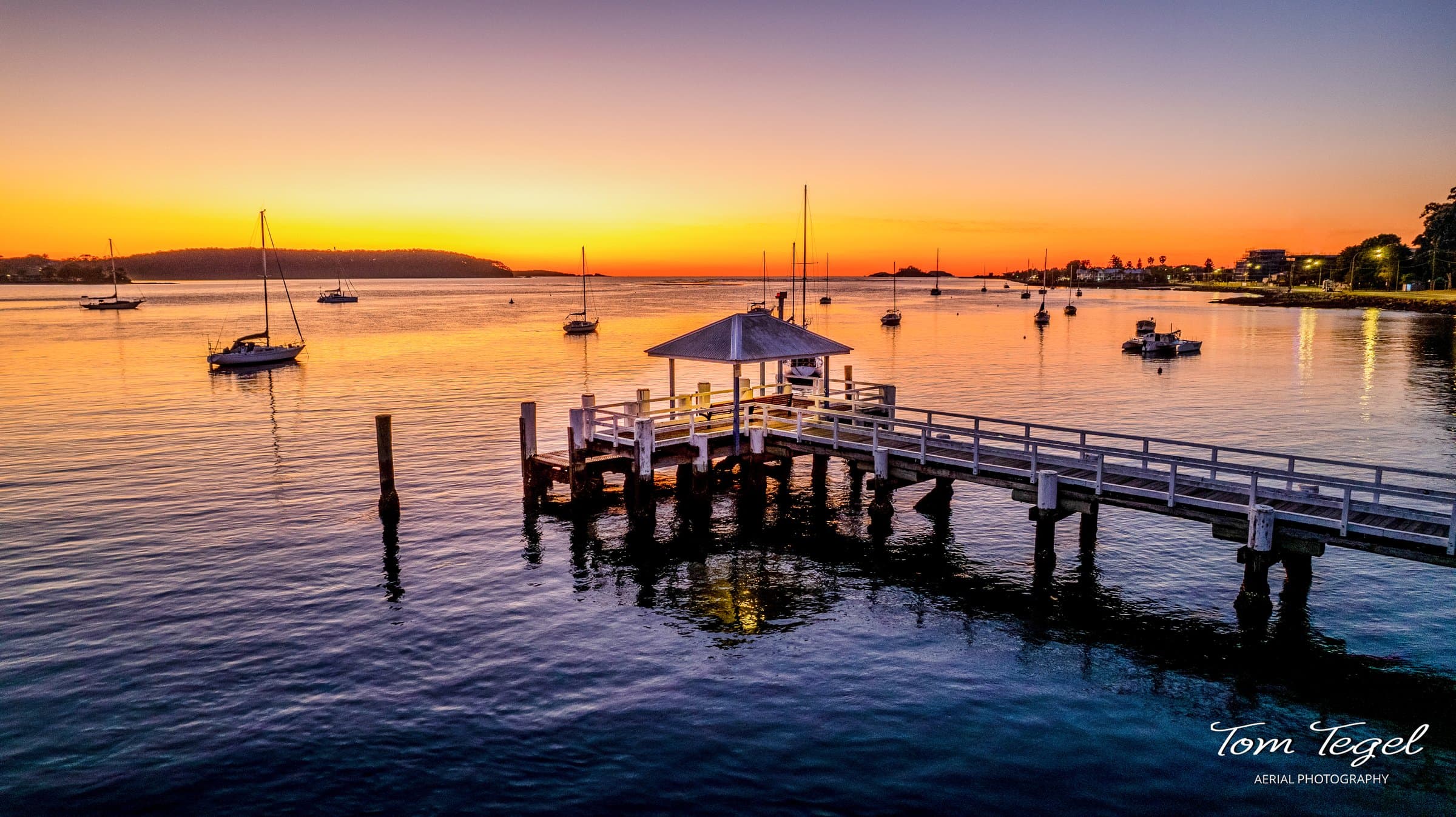 Batemans Bay wharf at sunrise, shot from above the water
